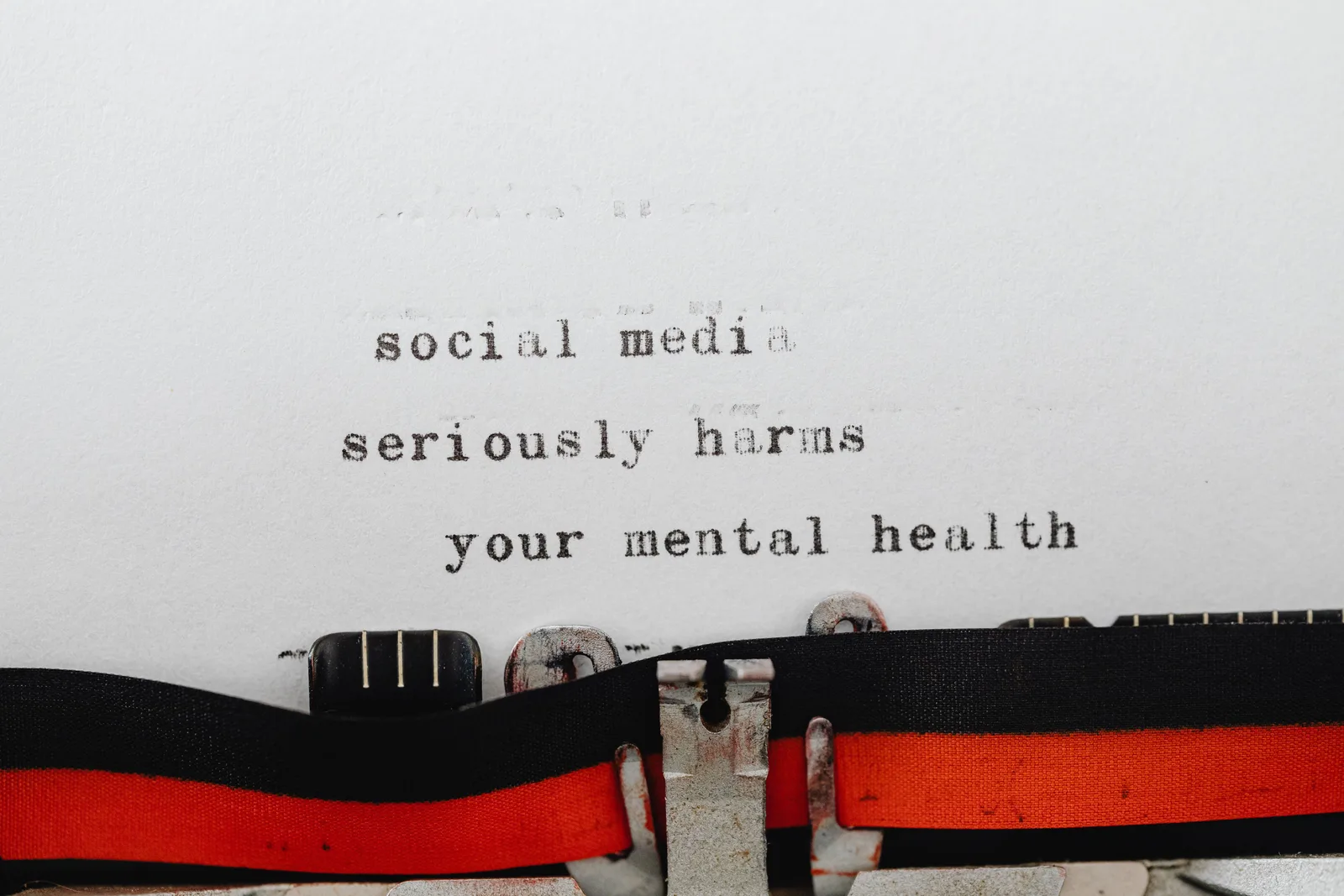 Vintage typewriter conveying message on social media's impact on mental health. Critiques of social media guide: sorting real complaints
